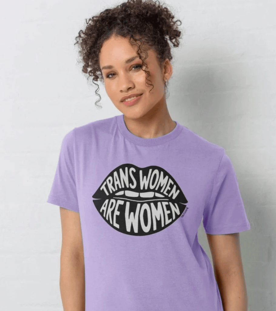 Model wearing purple Trans Women Are Women t-shirt by Fox Fisher, hand-drawn lips design on organic cotton, inclusive trans pride tee