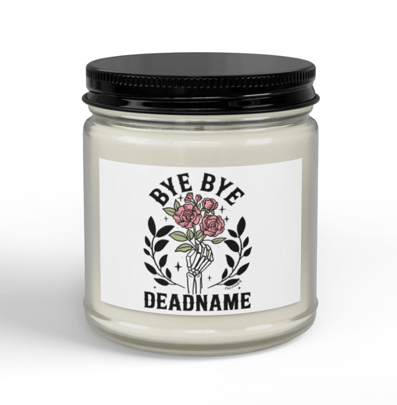 Bye Bye Deadname soy wax candle in clear glass jar with black lid, showing skeleton hand and roses label by Fox Fisher, name change celebration gift